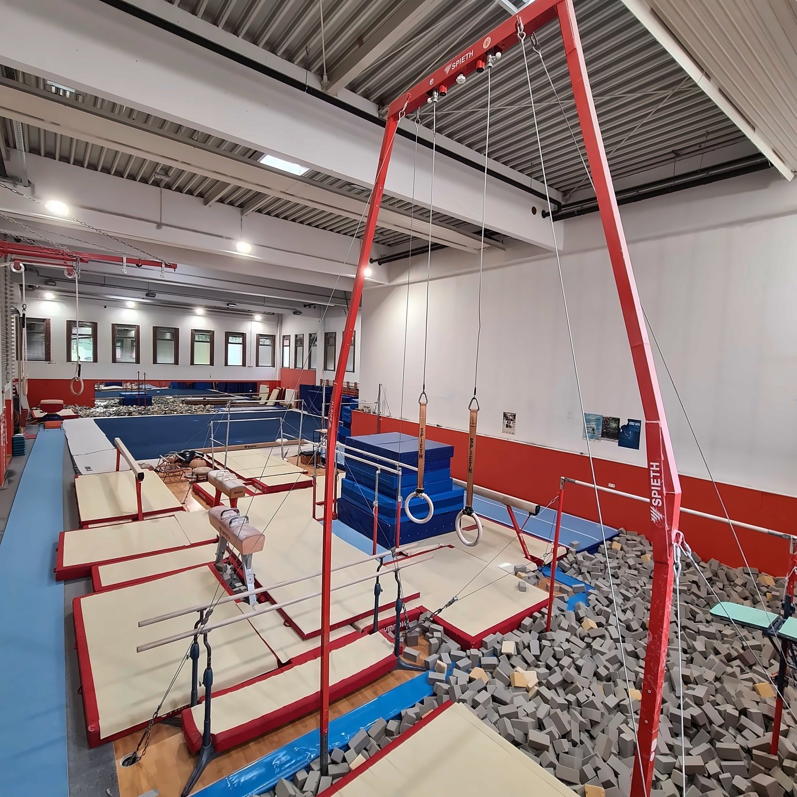 Krogi, bradlja, konj z ročaji in jama s penastimi kockami v telovadnici Gimnastične šole Ruše